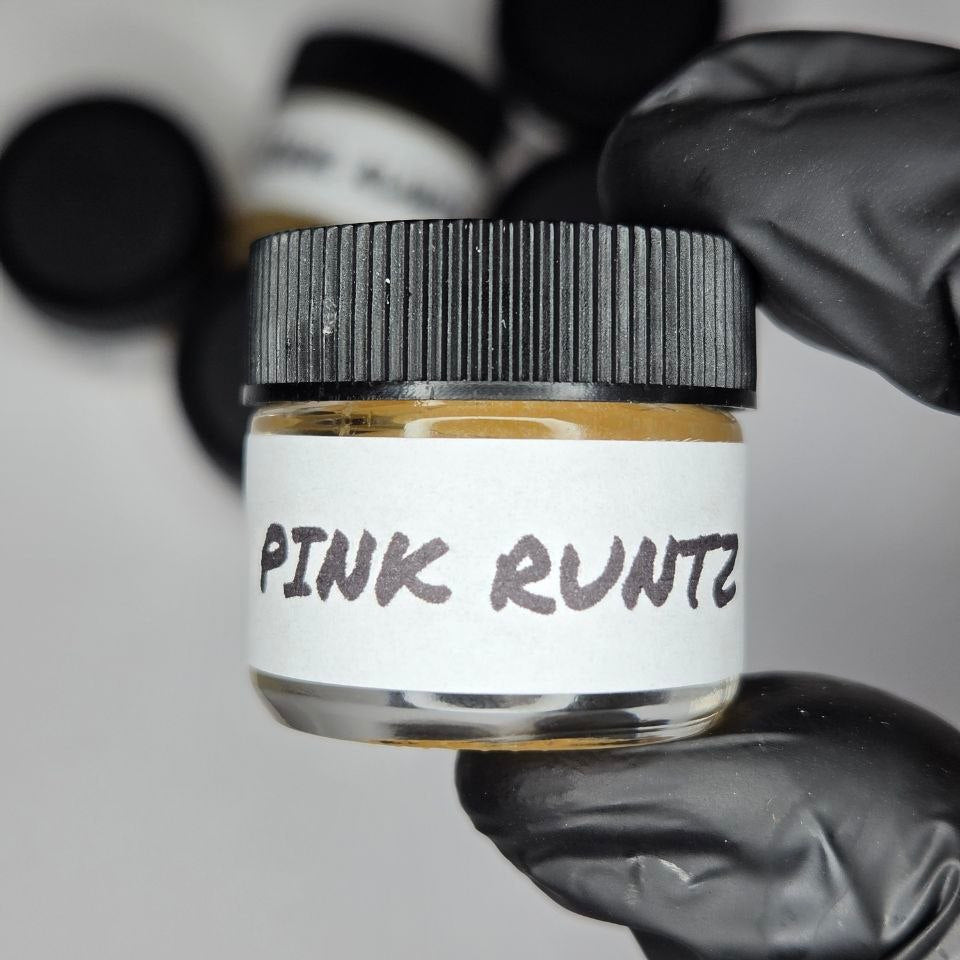 Jar labeled 'Pink Runtz' held by a gloved hand against a blurred background